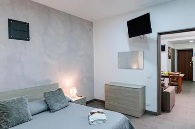 a bedroom with a bed and a living room at Meschita Little House in Palermo