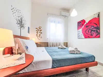 a bedroom with a large bed with towels on it at Villa Blu Corallo by Interhome in Alcamo Marina