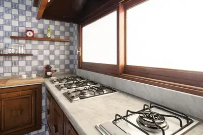 a kitchen with a stove top and a window at Villa Castelforte, con piscina a Mondello in Palermo