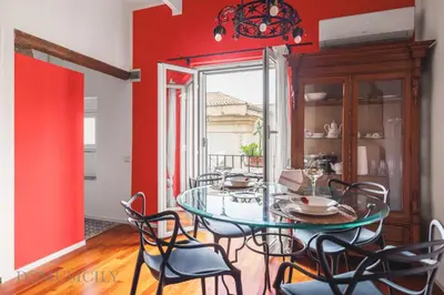 a dining room with a glass table and chairs at Cala & Cassari View By DomuSicily in Palermo