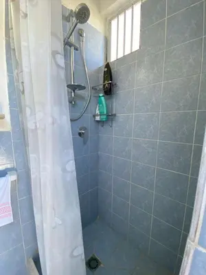 a shower with a shower curtain in a bathroom at Villa dei Gerani, a 500 mt dal mare in Alcamo
