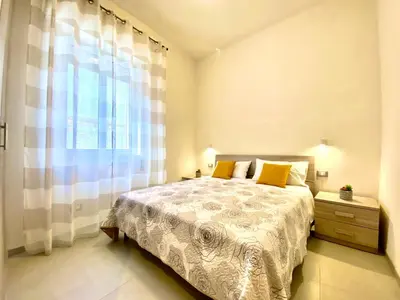a bedroom with a bed and a large window at Villa dei Gerani, a 500 mt dal mare in Alcamo