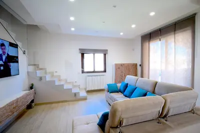 a living room with a couch and a tv at Private Villa, Sun & Pool in Mandra Capreria