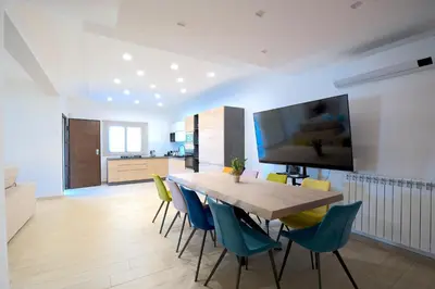 a kitchen and dining room with a table and chairs at Private Villa, Sun & Pool in Mandra Capreria