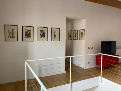 a room with a staircase and a wall with pictures at Dai Pupi al 68 in Palermo