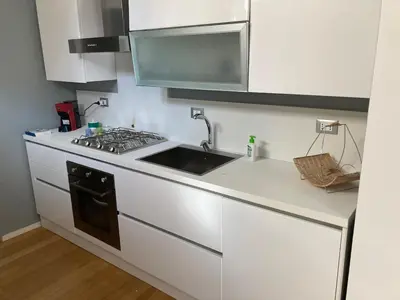 a kitchen with a sink and a stove at Dai Pupi al 68 in Palermo