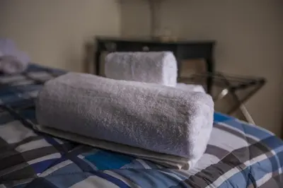 two towels sitting on top of a bed at La Bucceria in Palermo