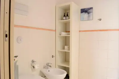 a bathroom with a toilet and a sink at Appartamento moderno tra Stazione, Via Maqueda e Ballarò in Palermo