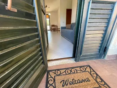 a door to a room with a welcome mat on the floor at Sweet Summer House in Campofelice di Roccella