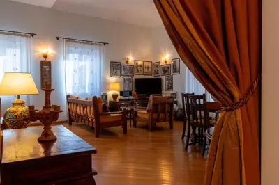 a living room with a table and chairs and a living room at GuestHost - Casa Giacomo in central Palermo in Palermo