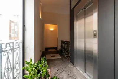 a hallway with a door and some plants in a building at GuestHost - Casa Giacomo in central Palermo in Palermo