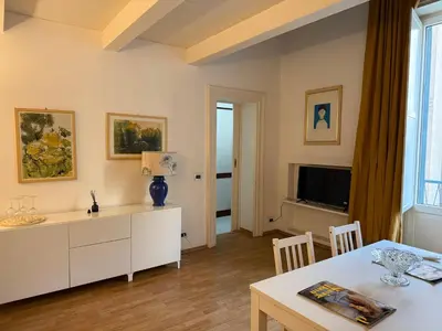 a living room with a table and a tv at La casa delle stelle in Palermo