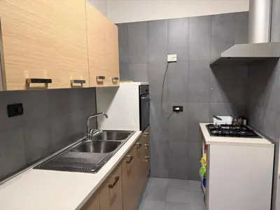 a small kitchen with a sink and a stove at La casa delle stelle in Palermo