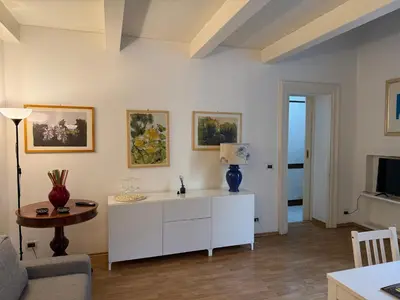 a living room with a white cabinet and a table at La casa delle stelle in Palermo