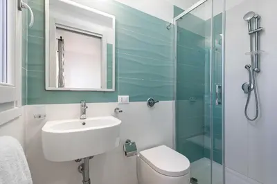 a bathroom with a sink and a glass shower at Panarea SVLC in San Vito lo Capo