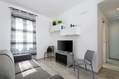 a living room with a couch and a tv at Panarea SVLC in San Vito lo Capo