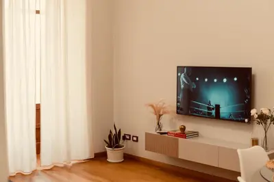 a living room with a flat screen tv on a wall at Dimora Beatrice in Termini Imerese