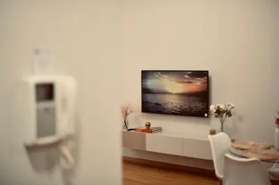 a living room with a tv on a wall at Dimora Beatrice in Termini Imerese