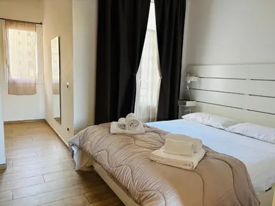 a bedroom with a bed with towels on it at Sampolo Rooftop - Palermo View in Palermo