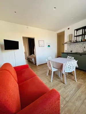 a living room with a red couch and a table at Sampolo Rooftop - Palermo View in Palermo