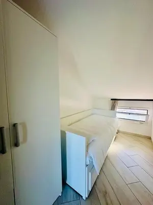a bedroom with a bed in a room with a window at Comfy Holiday House in Castellammare del Golfo