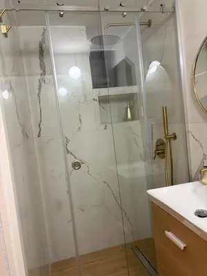 a shower with a glass door in a bathroom at A casa del capo in Palermo