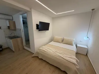 a bedroom with a bed and a tv on the wall at A casa del capo in Palermo