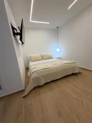 a bedroom with a bed in a white room at A casa del capo in Palermo