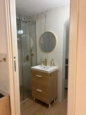 a bathroom with a sink and a glass shower at A casa del capo in Palermo