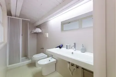 a bathroom with a white sink and a toilet at Hola House Politeama Theatre in Palermo