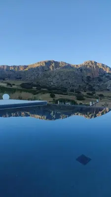an aerial view of a lake with mountains in the background at Villa Muntaja in Scopello