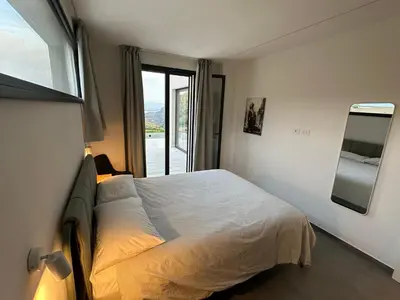 a bedroom with a bed and a window at Villa Muntaja in Scopello