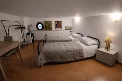 a bedroom with a blue bed with towels on it at A due passi dal Teatro Massimo in Palermo