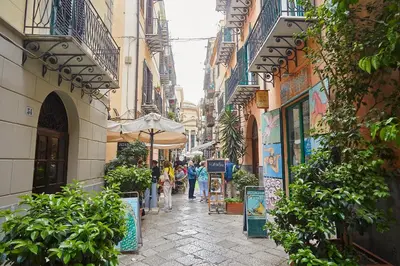 a street in a city with people walking down the street at A due passi dal Teatro Massimo in Palermo