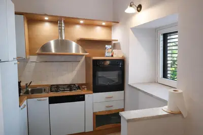 a kitchen with a sink and a stove top oven at A due passi dal Teatro Massimo in Palermo