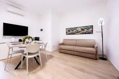 a living room with a table and a couch at A due passi dal mare in Palermo