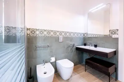 a bathroom with a toilet and a sink at A due passi dal mare in Palermo