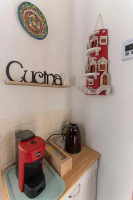 a red coffee maker on a counter in a kitchen at Casa Botanica Apartment in Palermo
