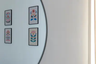 a group of framed pictures on a wall at Casa Botanica Apartment in Palermo