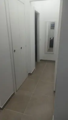 an empty hallway with white cabinets and a tile floor at Casa Bruno in Palermo