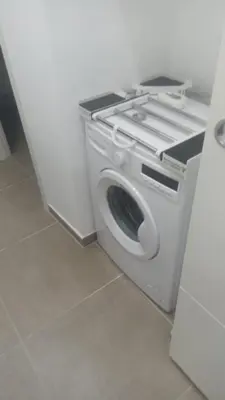 a washing machine is sitting in a room at Casa Bruno in Palermo