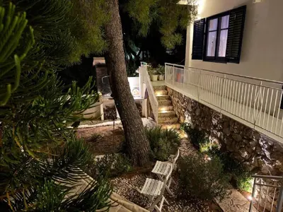 a staircase leading to a house with a tree at Sicily Sea Villa Capo Zafferano in Santa Flavia