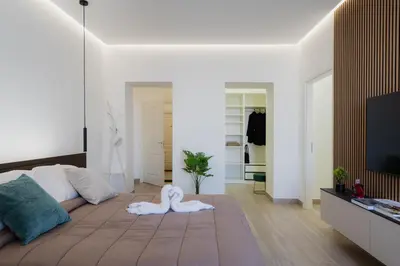 a living room with a bed and a flat screen tv at Casabea in Palermo