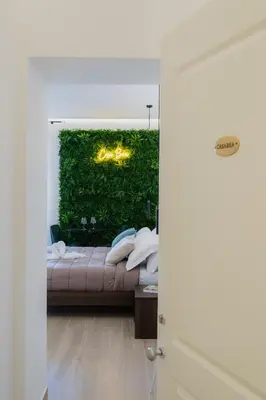 a bedroom with a bed and a green wall at Casabea in Palermo