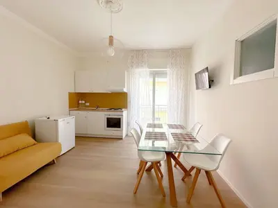 a living room with a glass table and white chairs at Cielo D'Alcamo Palazzo Antichi Quartieri in Alcamo