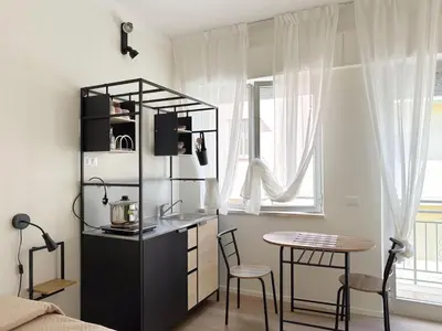 a room with a kitchen and a table and a counter at Cielo D'Alcamo Palazzo Antichi Quartieri in Alcamo