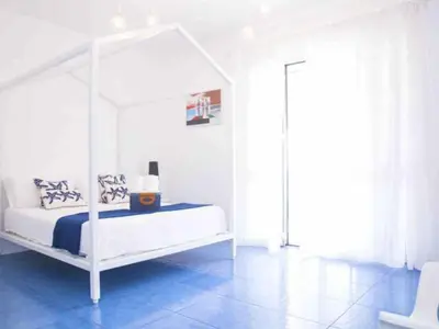 a bedroom with a white bed with a canopy at Apartment Villa am Meer Trappeto by Interhome in Trappeto