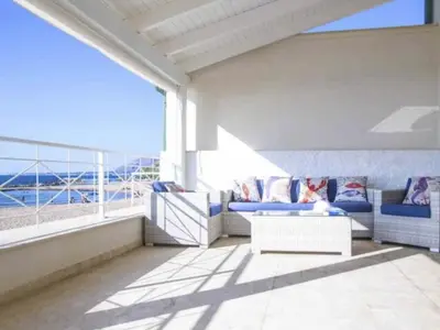 a balcony with couches and a view of the ocean at Apartment Villa am Meer Trappeto by Interhome in Trappeto