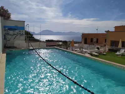 a large swimming pool with a view of the water at Apartment für 6 oder 7 Personen by Interhome in Balestrate