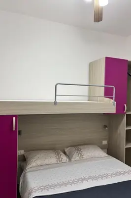 a bedroom with a bunk bed with a purple cabinet at Apartment für 6 oder 7 Personen by Interhome in Balestrate